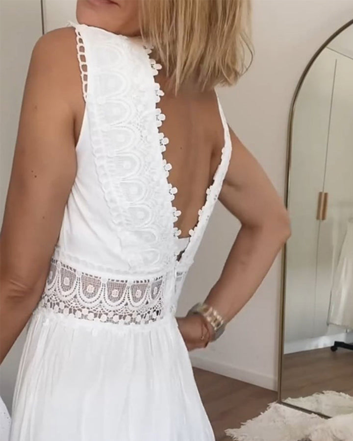 Woman wearing the Marian™ camisole maxi dress with delicate detailing and a flowing skirt at a summer gathering.