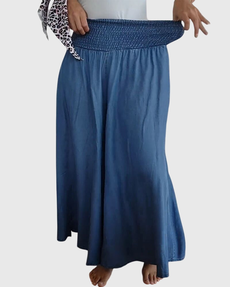 A woman in wide-leg trousers with a high elastic waist, styled for a relaxed boho look.