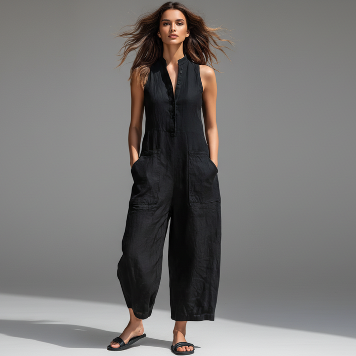 Minimalist white jumpsuit with front button detail and a relaxed fluid silhouette