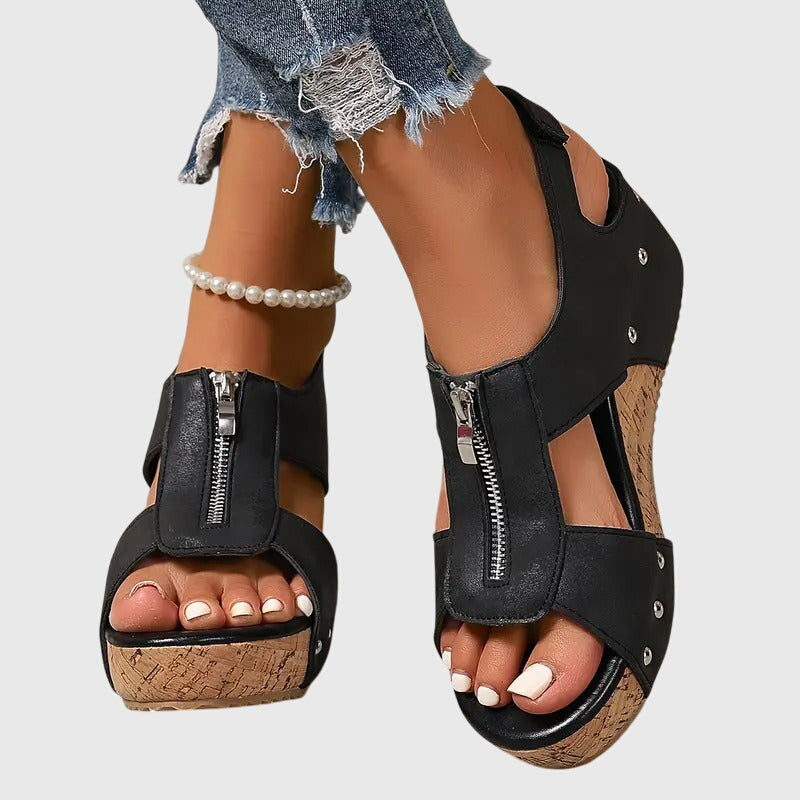 A woman standing at ease in wide-fit supportive comfort sandals with adjustable straps.