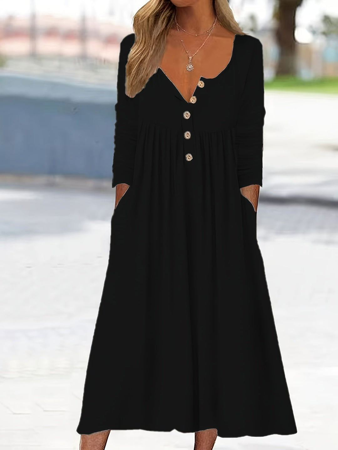 A woman wearing the Bernadette button-front midi dress with an A-line skirt, dressed for a casual day out.