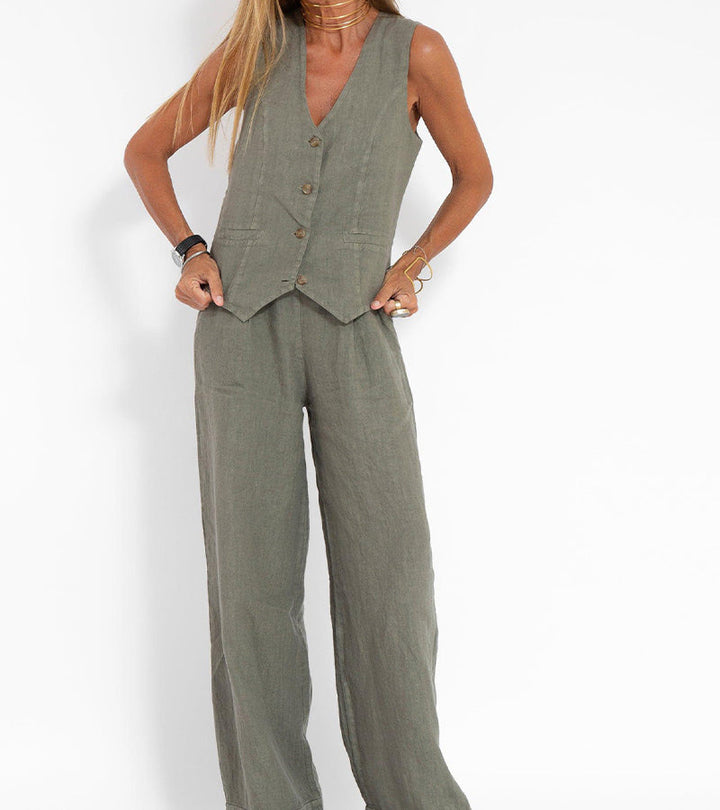 A woman wearing a tailored waistcoat with flowing wide-leg trousers