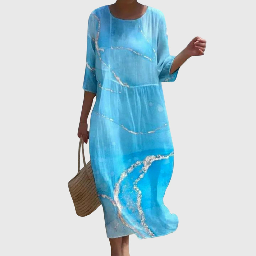 Woman wearing a long flowing maxi dress with a delicate floral print, moving gracefully.