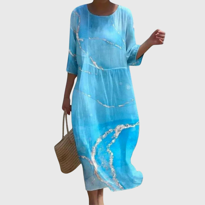 Woman wearing a long flowing maxi dress with a delicate floral print, moving gracefully.