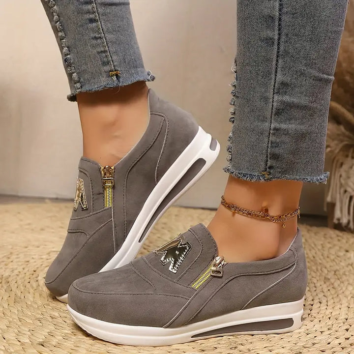 A woman wearing cushioned side-zip trainers with a relaxed everyday outfit