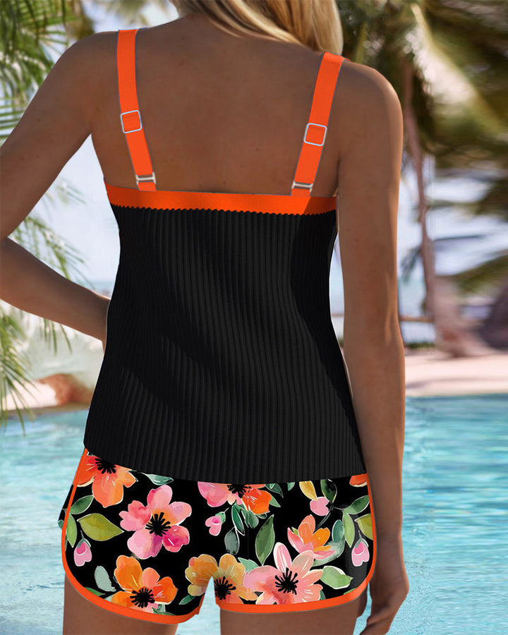 Tankini set with orange tropical-print shorts and matching top