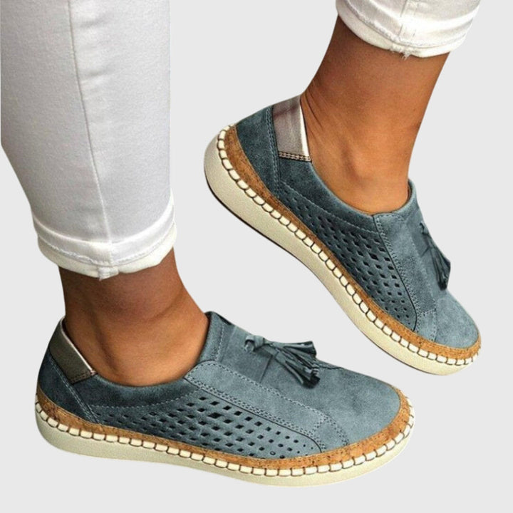 A woman wearing comfortable orthopaedic slip-on shoes on a summer day