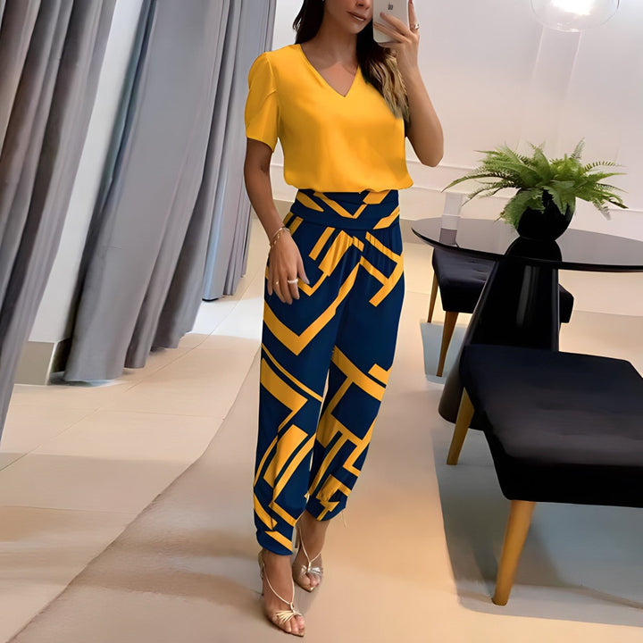 A woman wearing a plain V-neck top with geometric print slim trousers, chic and comfortable.