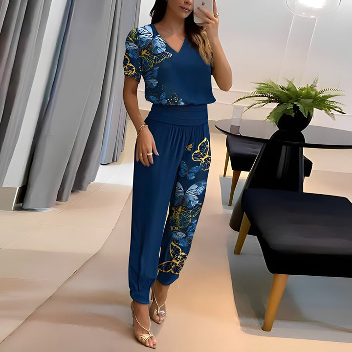 A woman wearing a plain V-neck top with geometric print slim trousers, chic and comfortable.
