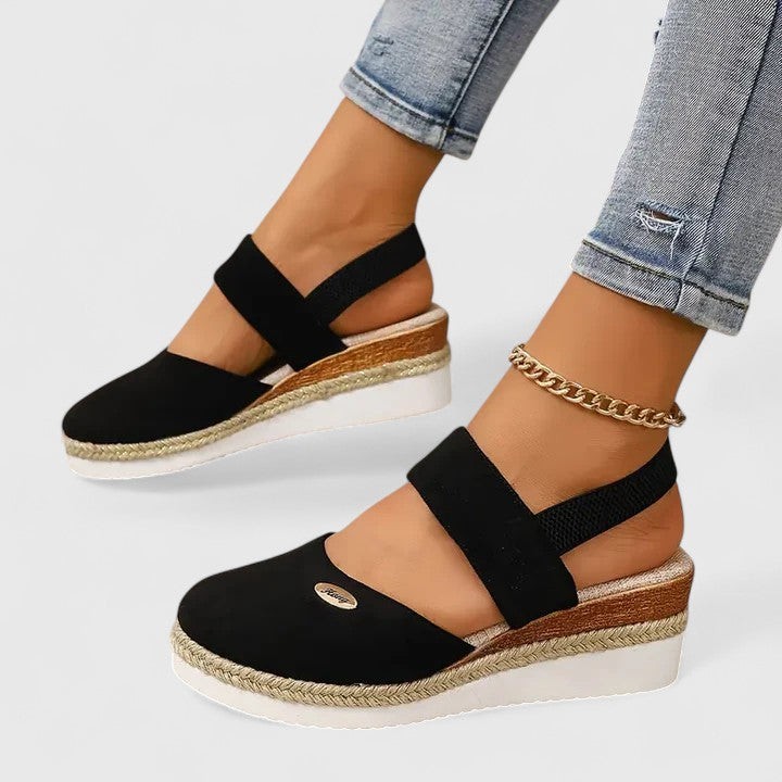 A woman in beige espadrille-inspired sandals stepping out comfortably on a bright morning.
