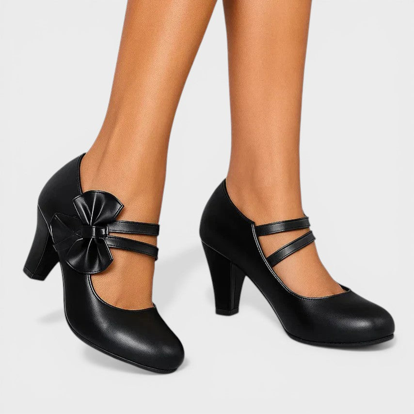 Women's mid-height heels in black with a soft delicate bow at the toe