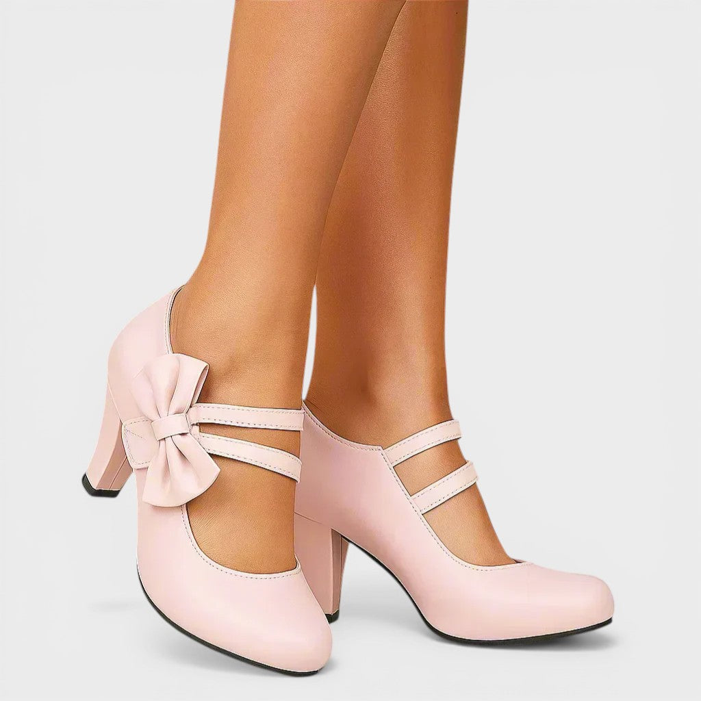 Women's mid-height heels in black with a soft delicate bow at the toe