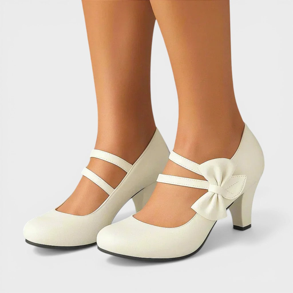 Women's mid-height heels in black with a soft delicate bow at the toe