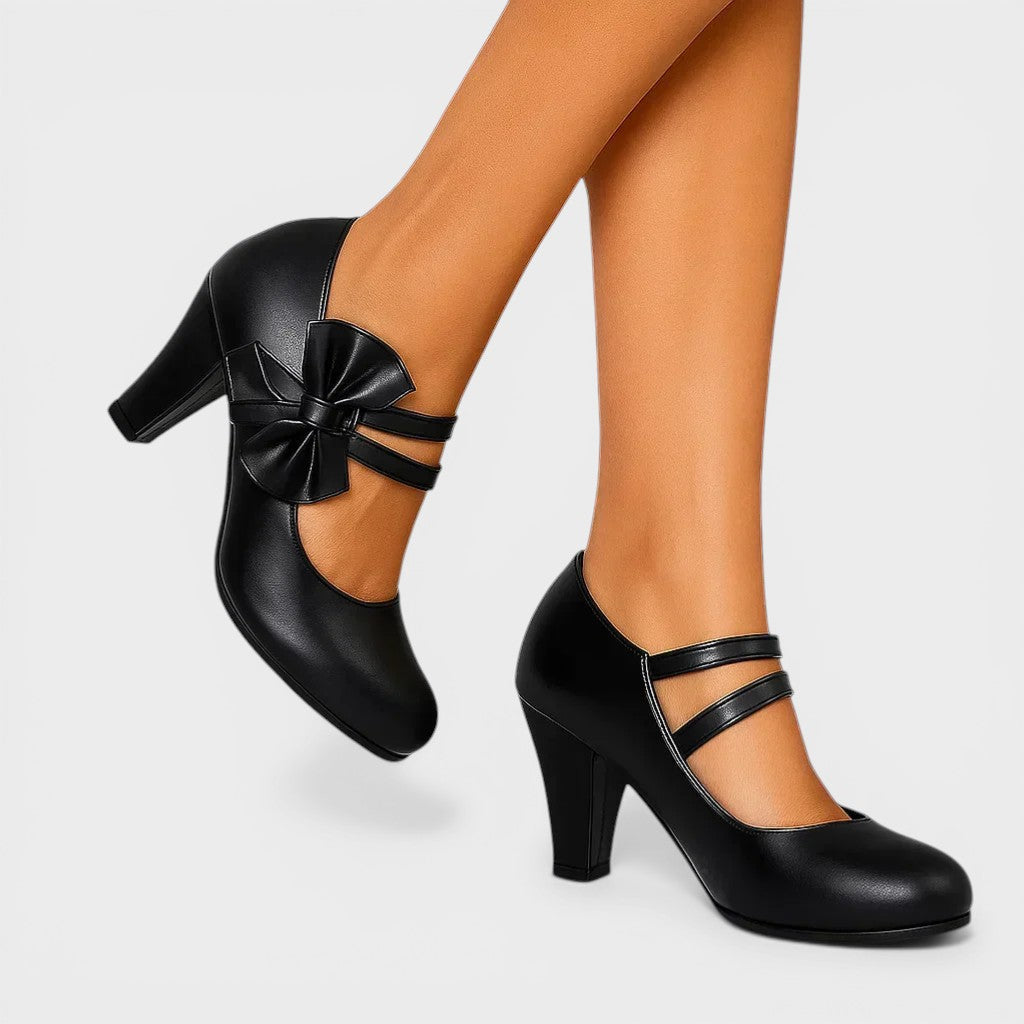 Women's mid-height heels in black with a soft delicate bow at the toe