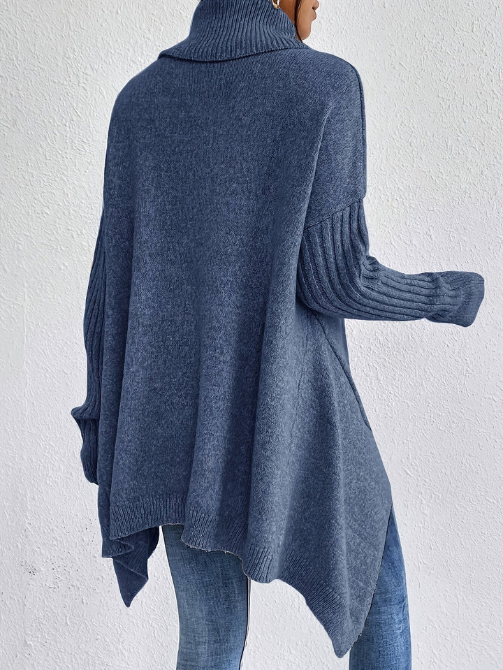 A woman wearing a stand-collar jumper with a chic asymmetric drape, warm and polished.