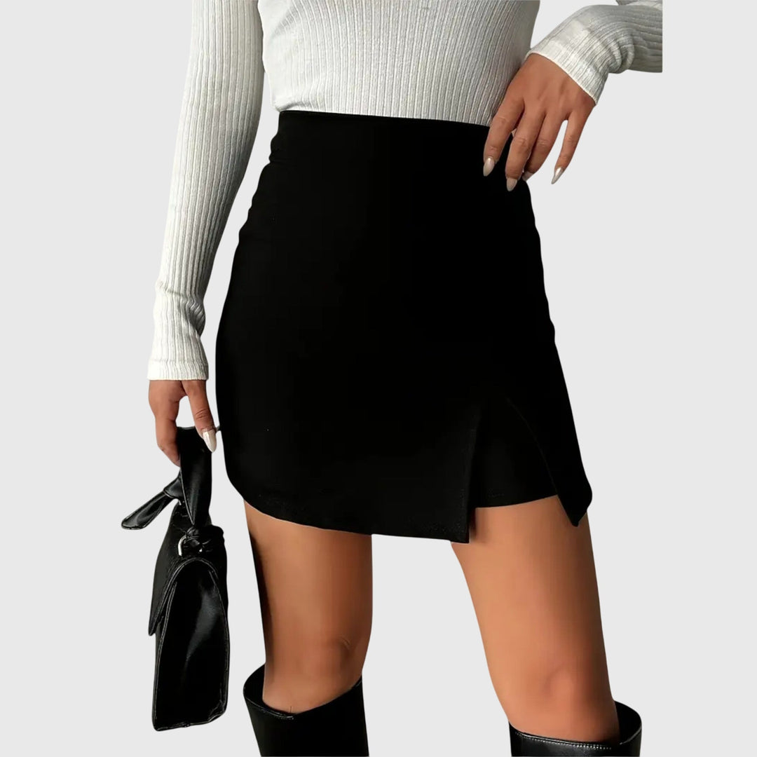 A woman wearing a sleek high-waisted black pencil skirt with a hem slit.