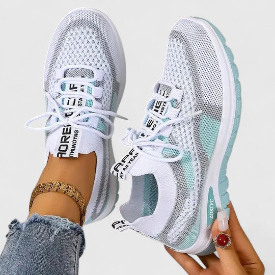 A woman lacing up light, breathable orthopaedic trainers before a walk.