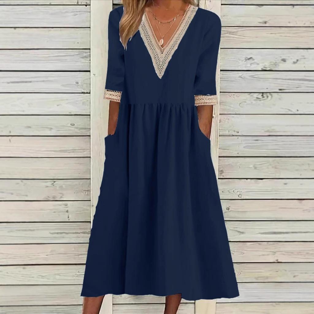 A woman wearing the Deirdre V-neck midi dress with delicate detailing at the collar and sleeves.