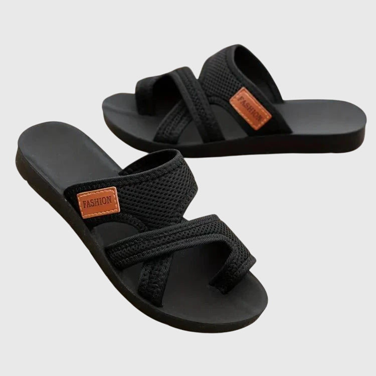Lightweight flat sandal in black, also available in red and brown, with a simple clean design