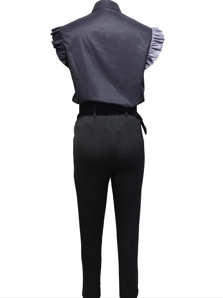 A woman wearing a floral ruffle-sleeve top with high-waisted trousers, elegant and striking.