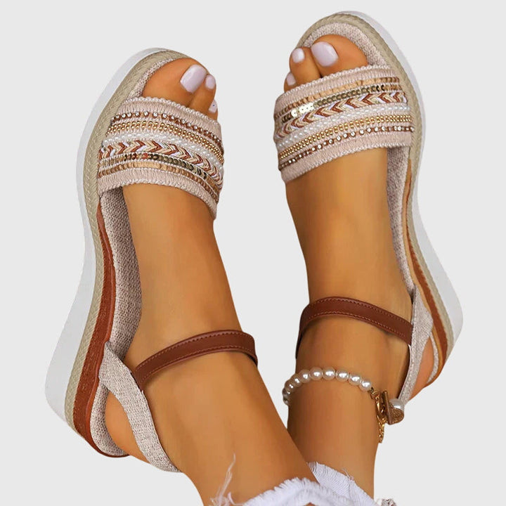 A woman walking easily in lightweight modern sandals in a soft white and brown finish.