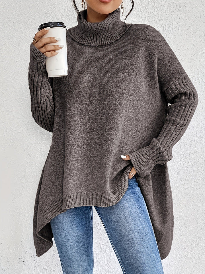A woman wearing a stand-collar jumper with a chic asymmetric drape, warm and polished.