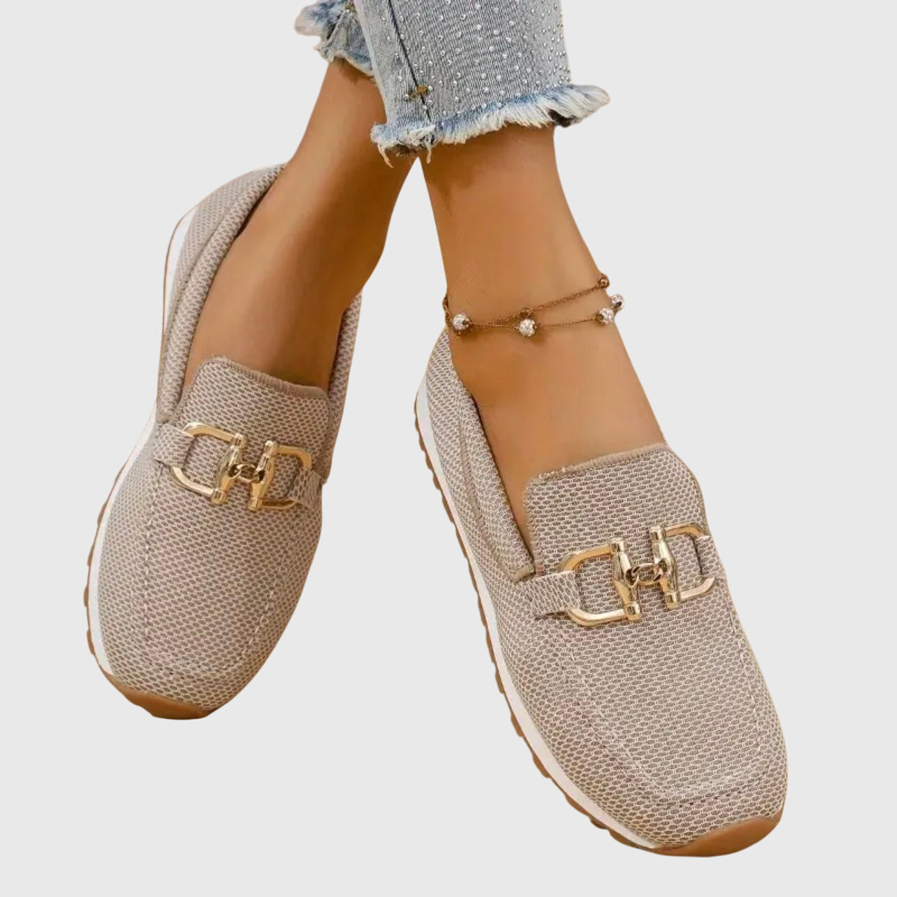 Women's beige comfort slip-on trainers with a cushioned sole and elegant metallic detail