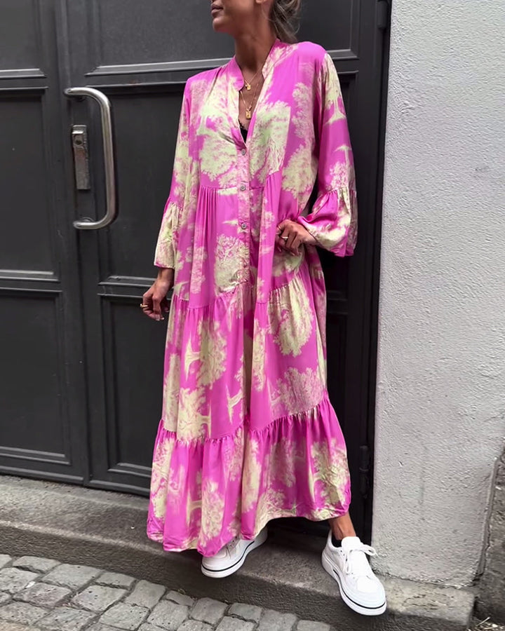 Woman wearing the Abigail flowing maxi dress with a delicate print and V-neckline, the skirt moving softly as she walks.