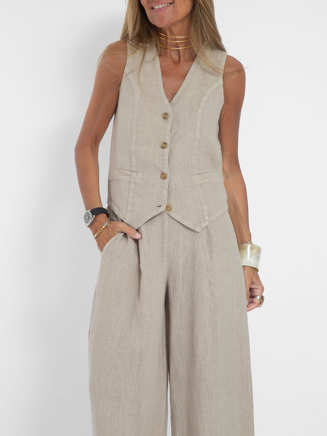 A woman wearing a tailored waistcoat with flowing wide-leg trousers