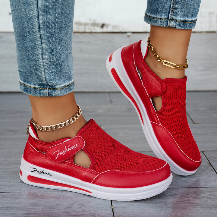 A woman slipping on breathable, cushioned slip-on trainers with trousers