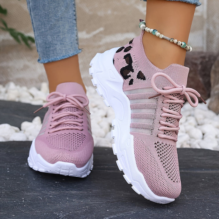 A woman walking in light, breathable comfort trainers on a warm day.