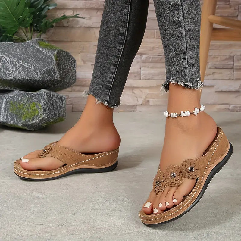 Women's floral toe-post sandals with a soft cushioned base in dark brown, black, navy, red and rose