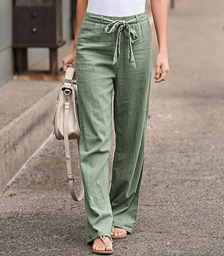 Woman wearing relaxed drawcord-waist trousers with a smart top, out for the day.