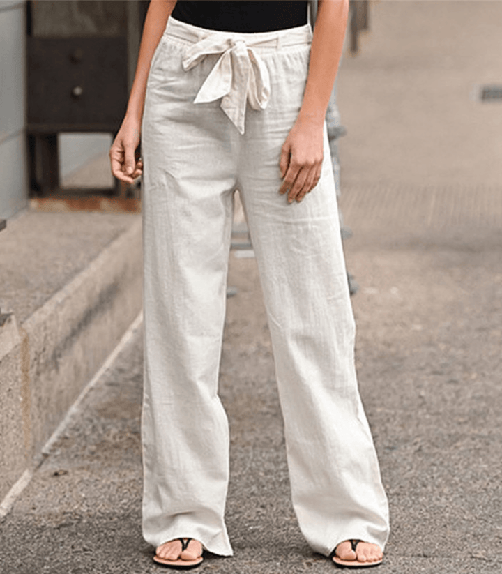 Woman wearing relaxed drawcord-waist trousers with a smart top, out for the day.