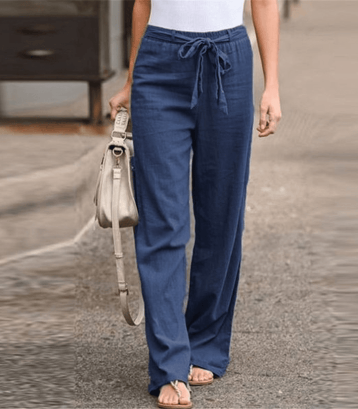 Woman wearing relaxed drawcord-waist trousers with a smart top, out for the day.