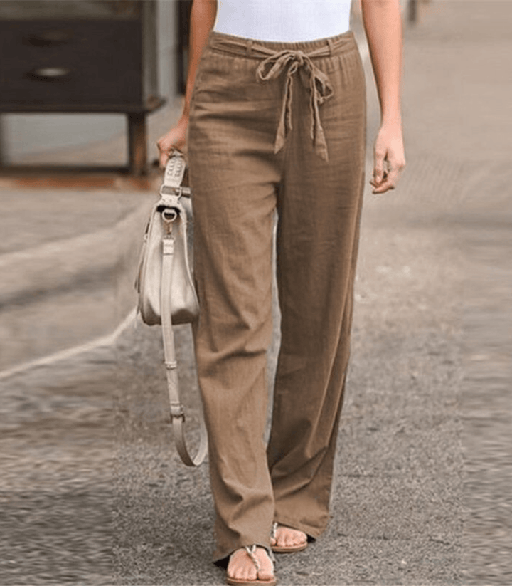 Woman wearing relaxed drawcord-waist trousers with a smart top, out for the day.