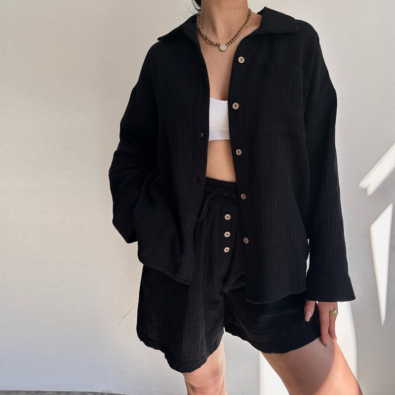 A woman wearing a flowing oversized shirt with drawstring shorts, relaxed and breezy.