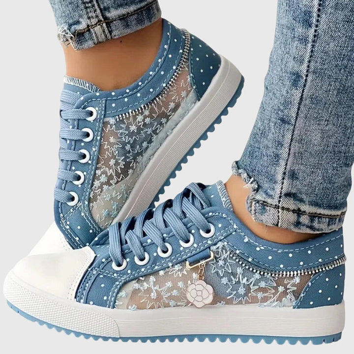 A woman walking comfortably in blue cushioned orthopaedic trainers