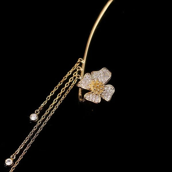 Gold celestial arc earring with a butterfly detail, framing the ear with sparkling luminosity