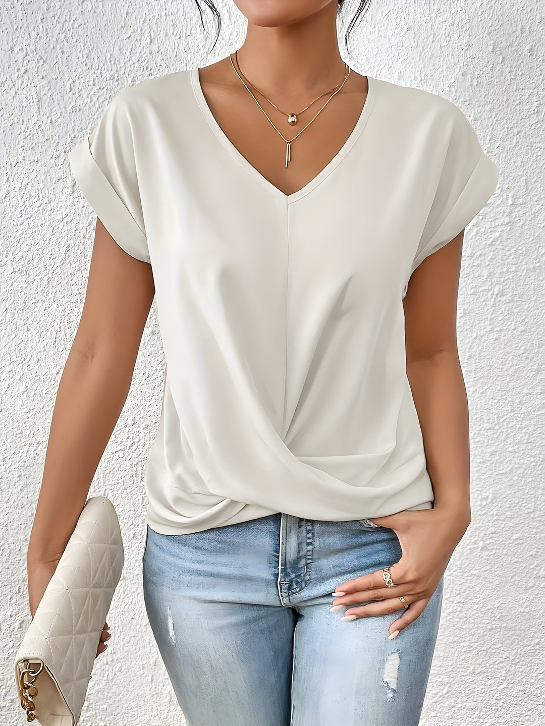 Pink V-neck top with a crossover-front detail and a relaxed, flattering silhouette
