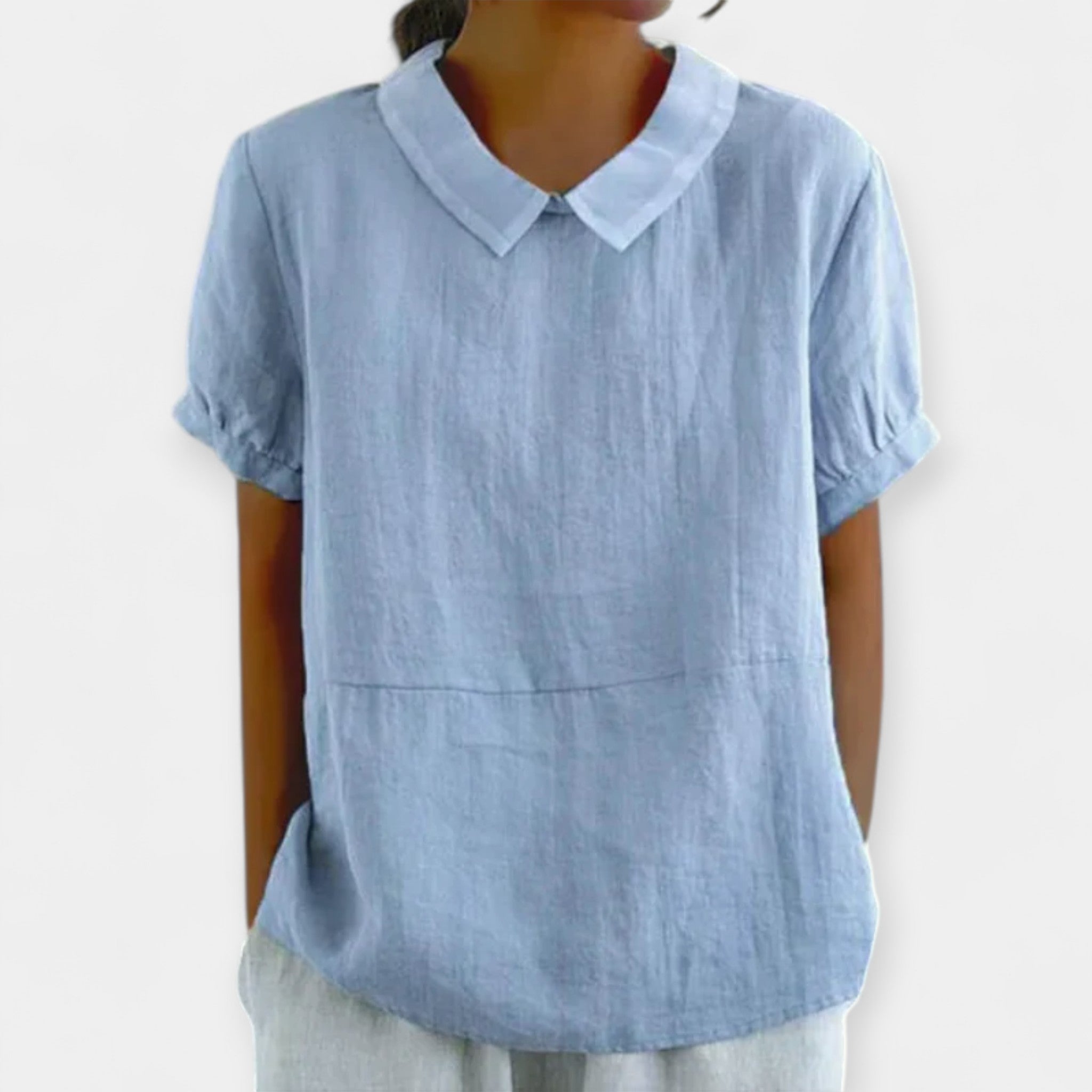 Women's fitted collar-neck top in pale blue with delicate embroidery and button detailing