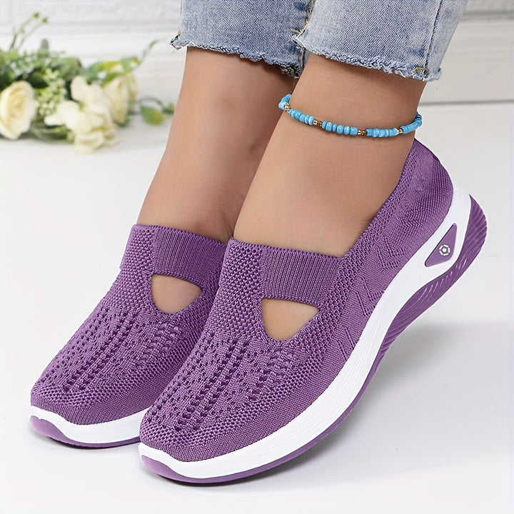 A woman stepping into easy slip-on comfort trainers with no laces.