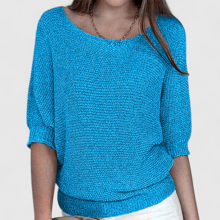 A woman wearing a soft purple jumper with a wide neckline and gently shaped fit.