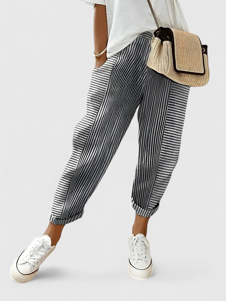 A woman wearing airy comfy summer trousers with an elastic waist and side pockets.