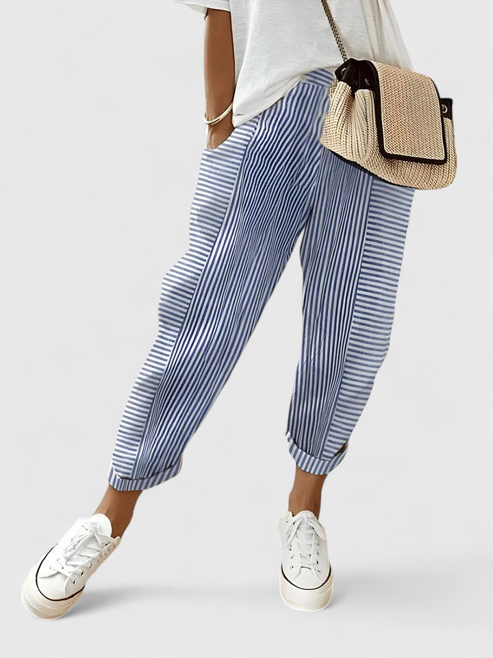 A woman wearing airy comfy summer trousers with an elastic waist and side pockets.