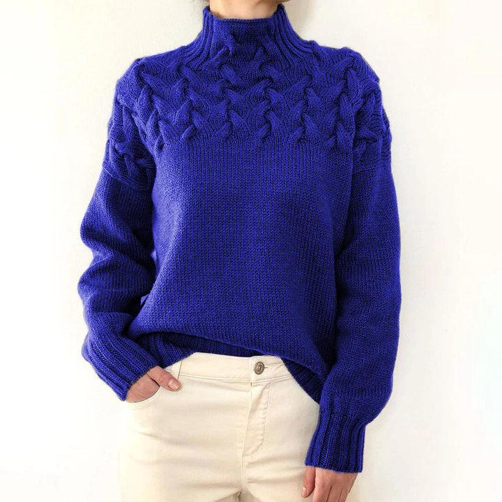 A woman wearing a warm roll-neck jumper, cosy and elegant on a cold winter day.