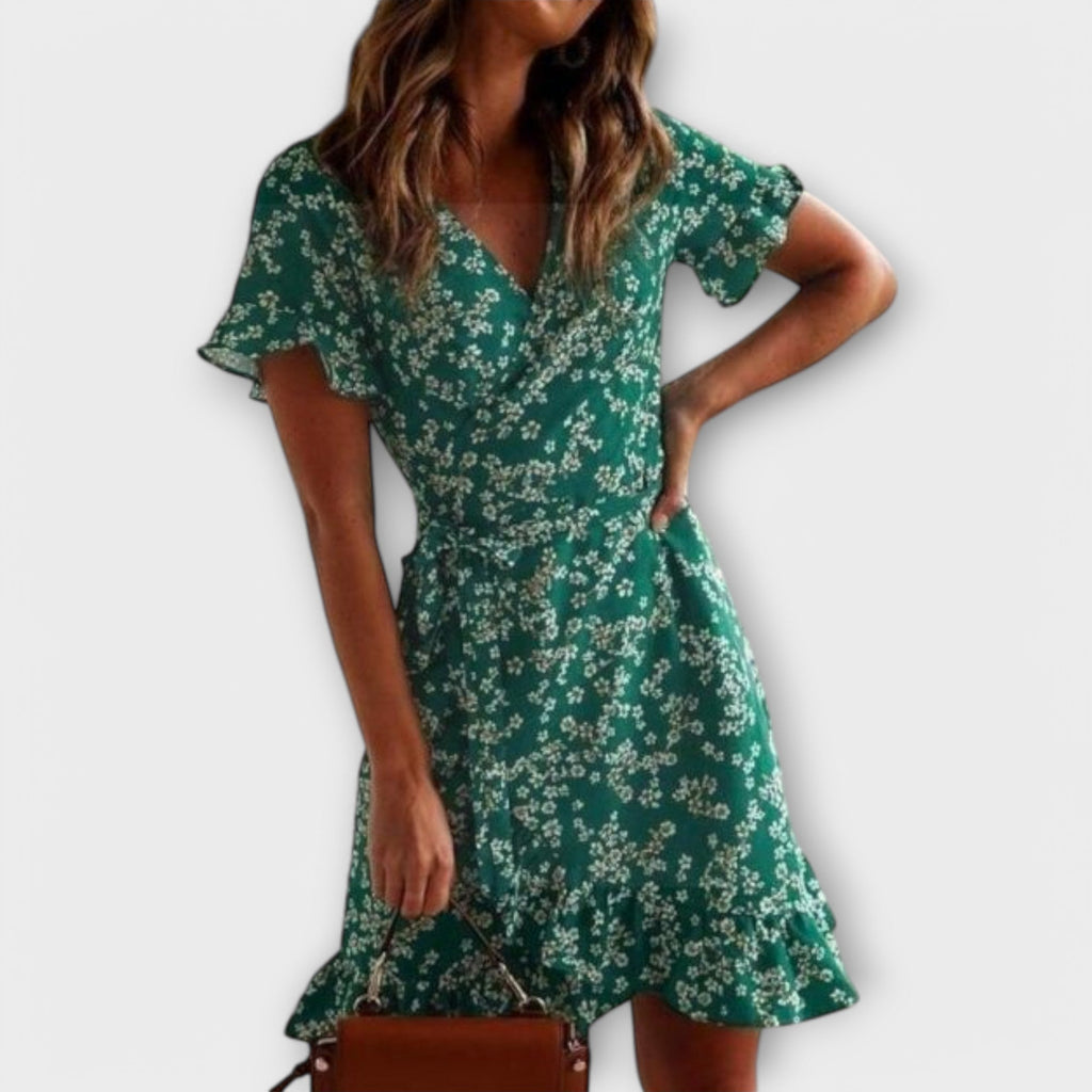 Short green floral boho dress with a nipped waist and feminine ruffled details