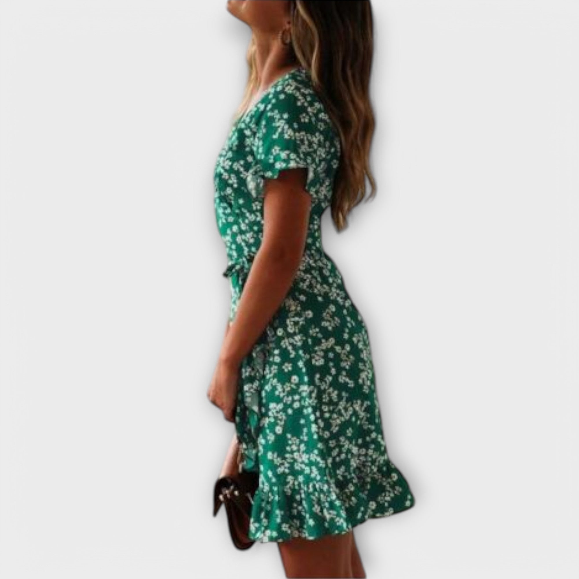 Short green floral boho dress with a nipped waist and feminine ruffled details