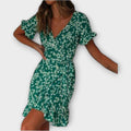 Short green floral boho dress with a nipped waist and feminine ruffled details
