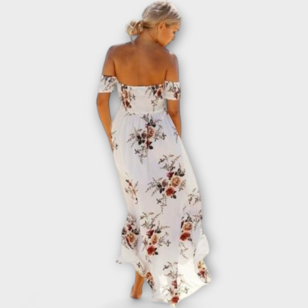 A white floral fluid midi dress with a gentle boho print, styled for a relaxed summer outing